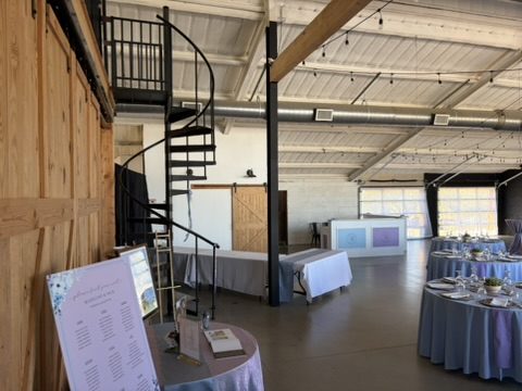 Welcome sign and seating chart by the spiral staircase